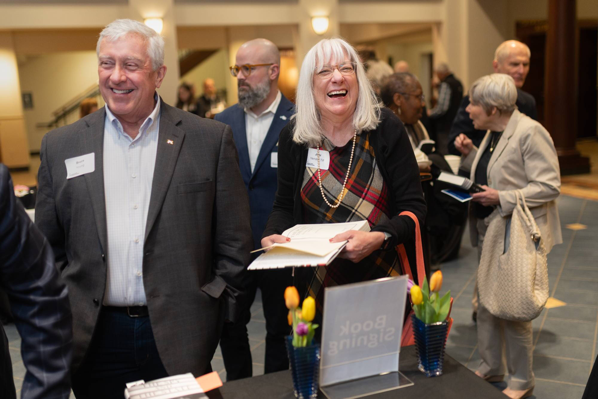 Event attendees wait in line to have their books signed